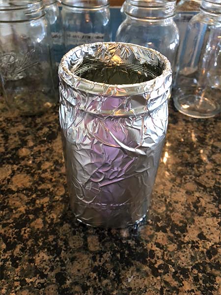 Mason Jar Hydroponics - Mason Jars wrapped in foil to block out light.